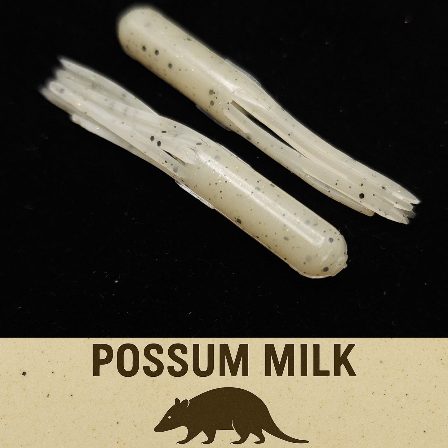 Two pieces of possum milk fishing lure on a black background with 'Possum Milk' text and logo.