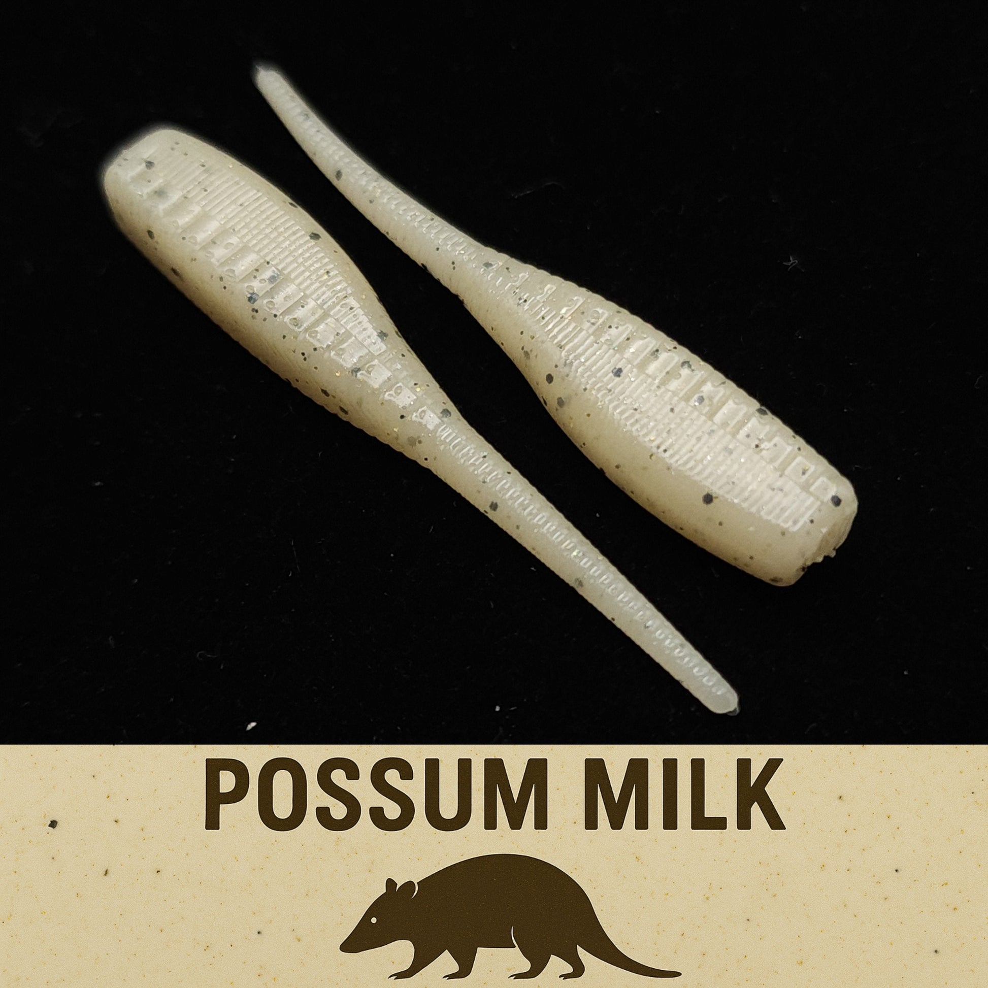 Two milky white fish lures on a black background with 'Possum Milk' text and logo.