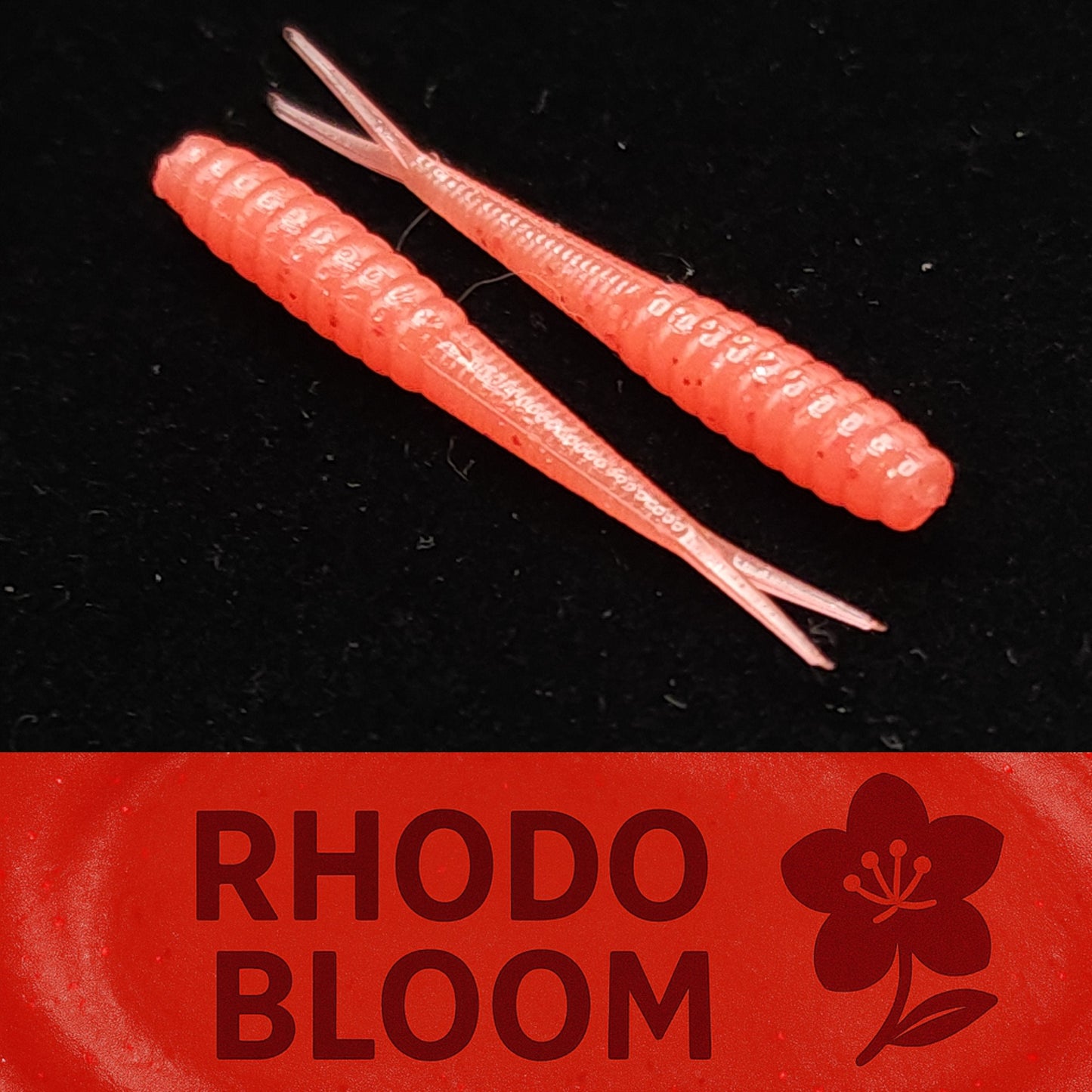 Two pink fishing lures on a black background with 'Rhodo Bloom' branding.