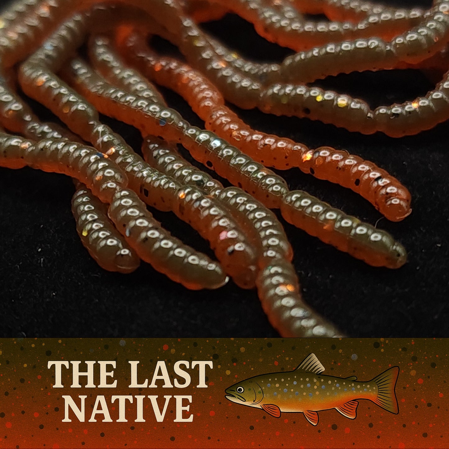 Close-up of fishing lures with 'The Last Native' branding on a dark background