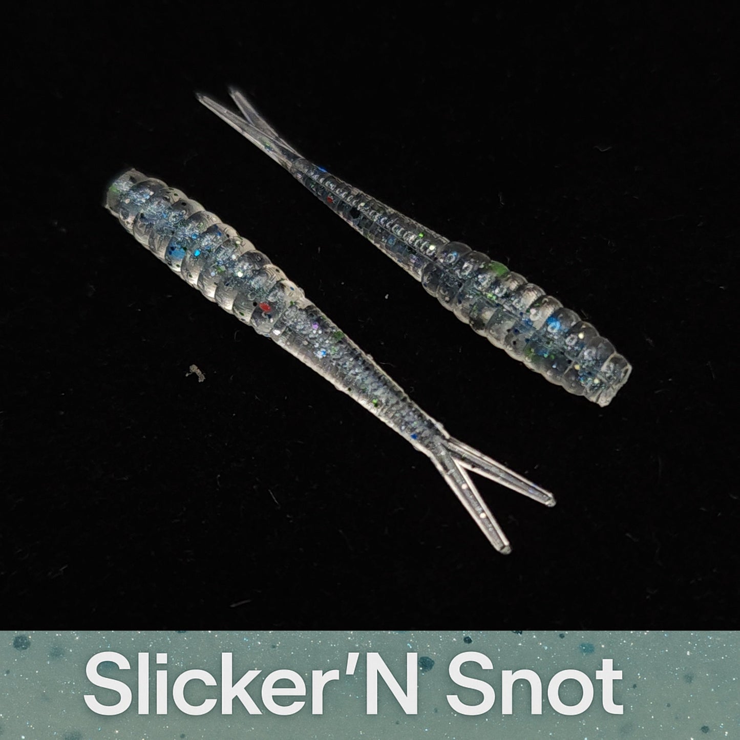Two fishing lures labeled 'Slicker'N Snot' on a black background
