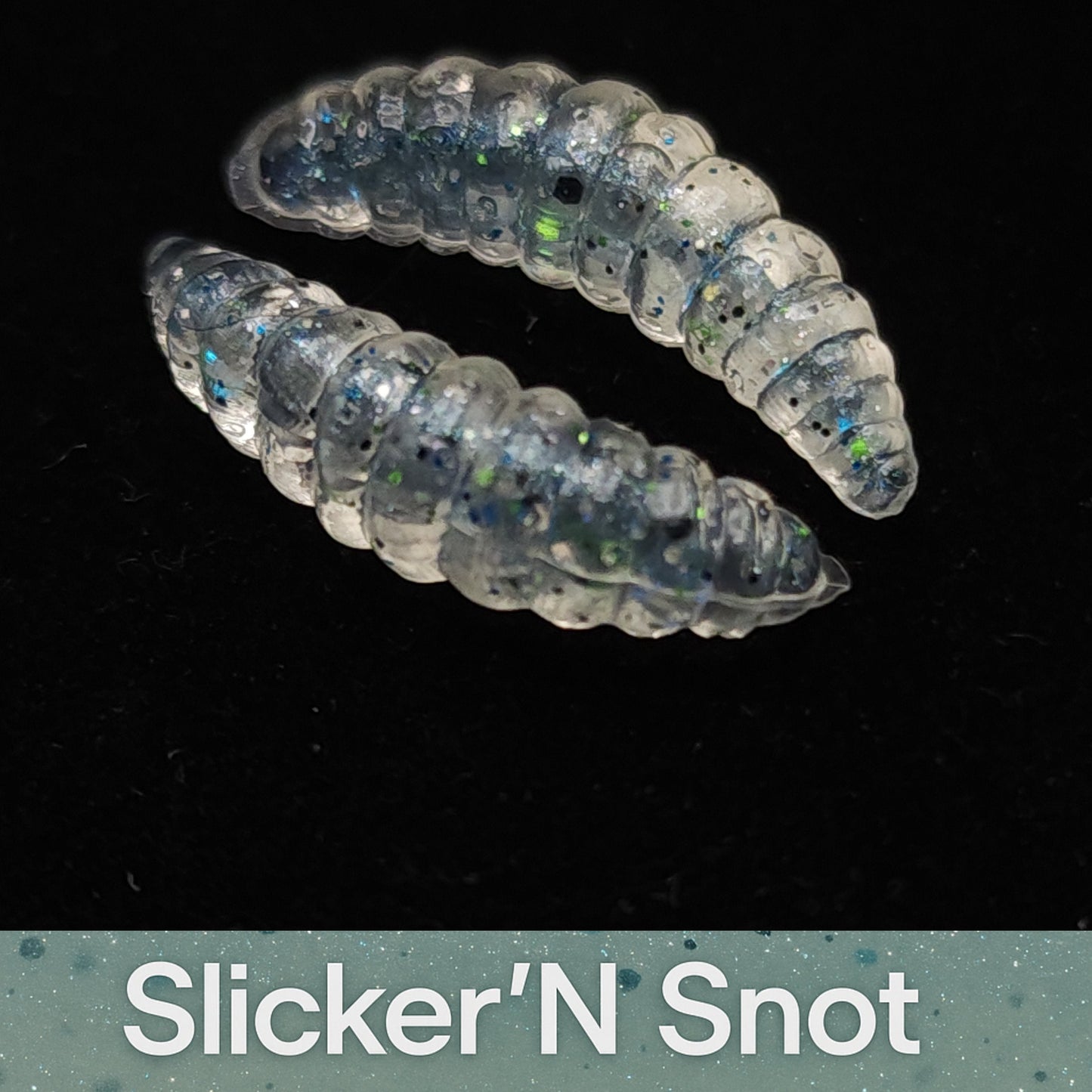 Transparent gel-like  fishing lures with glittery texture on a black background, labeled 'Slicker'N Snot'.