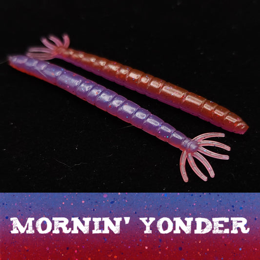 Two fishing lures with a 'Mornin' Yonder' label on a dark background