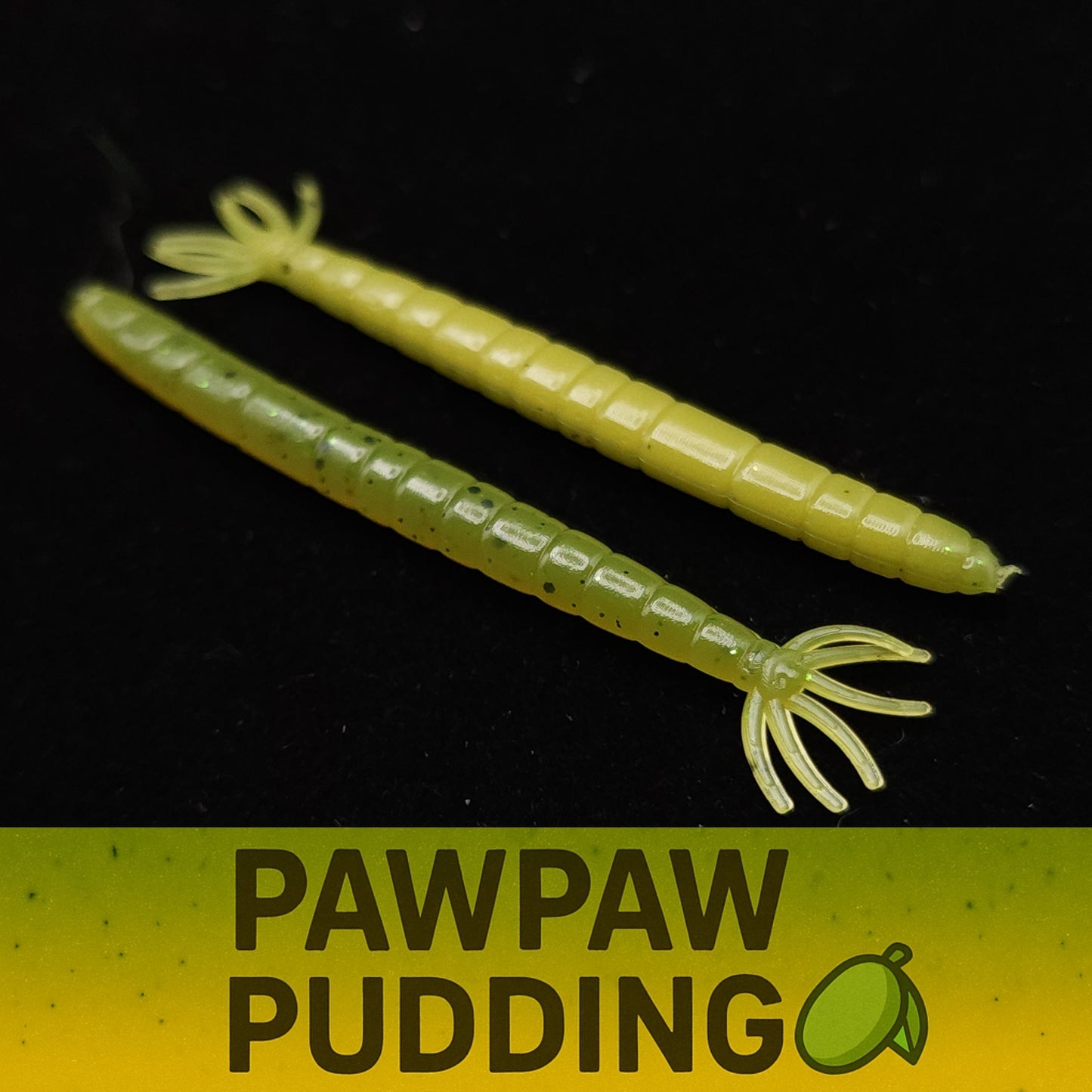 Two green fishing lures labeled 'Pawpaw Pudding' on a black background