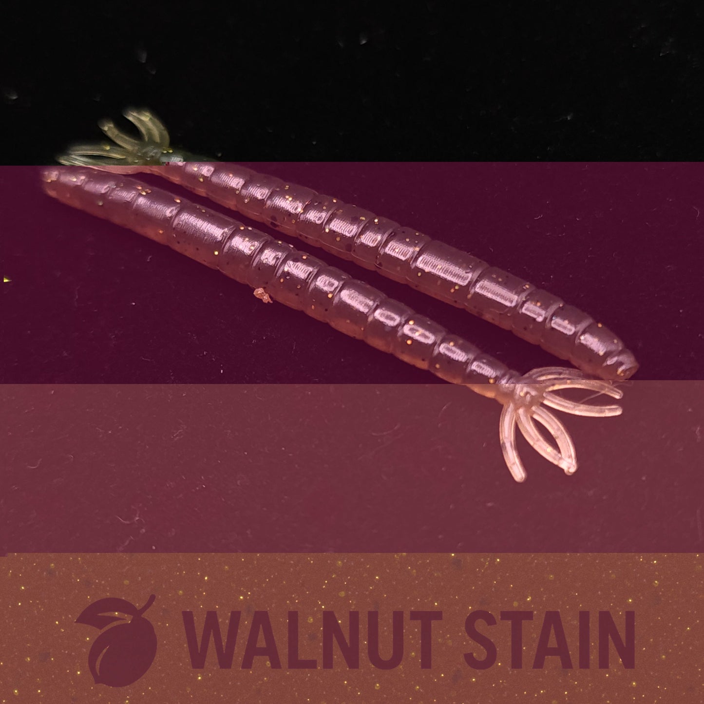 Two purple worm  fishing lures on a dark background with 'Walnut Stain' text.