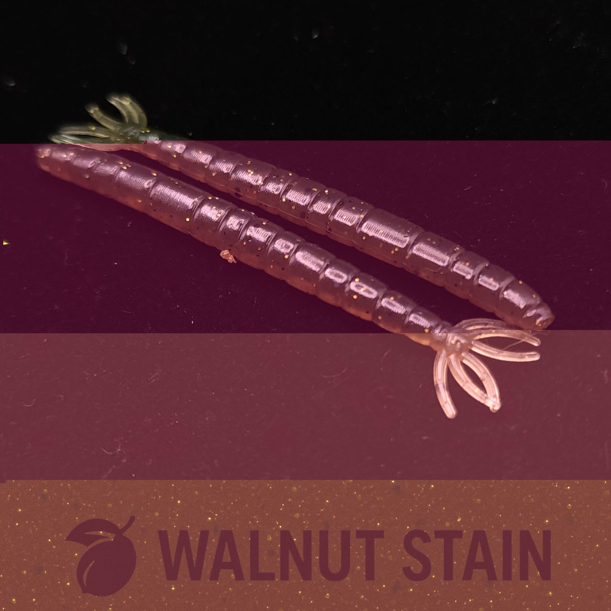 Two purple worm  fishing lures on a dark background with 'Walnut Stain' text.