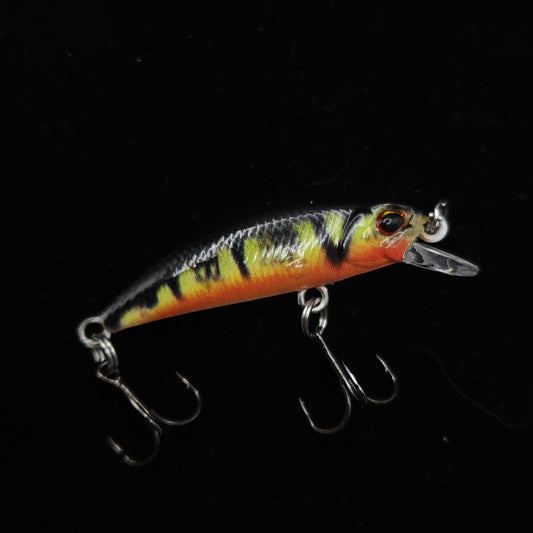 Fishing lure with a colorful pattern on a black background