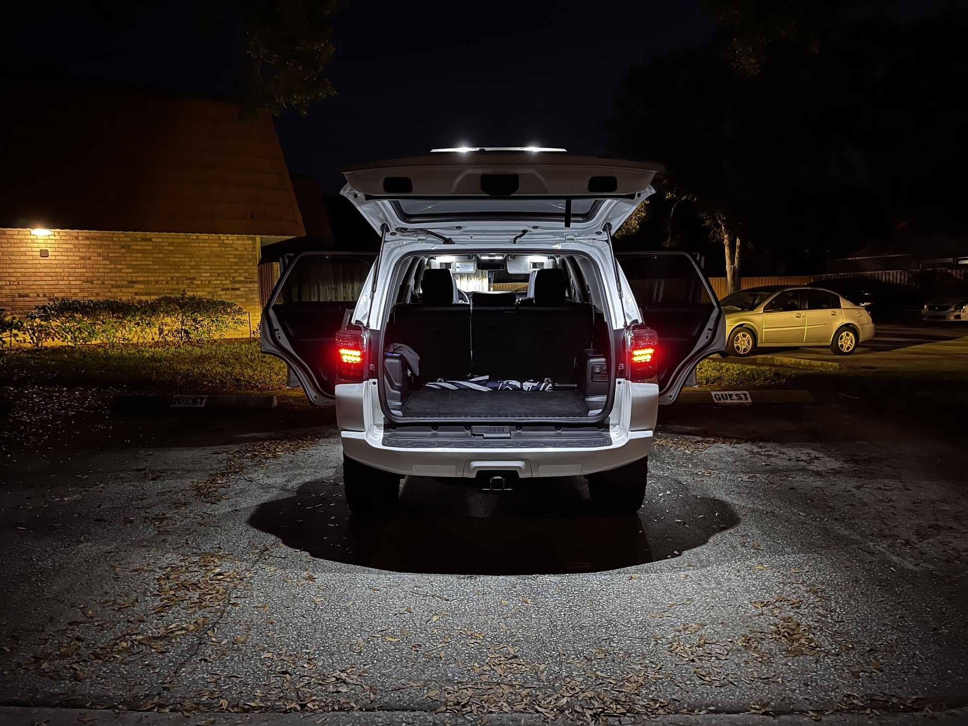 Car with open trunk at night in a parking lot