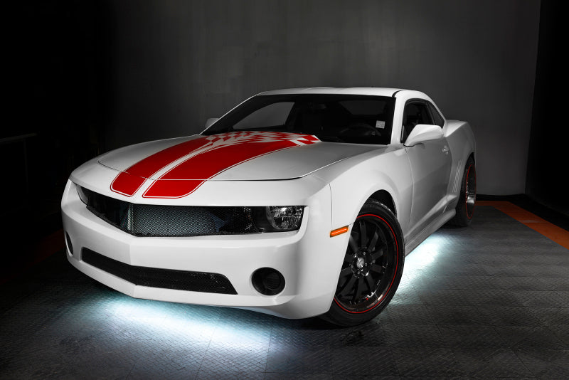 White muscle car with underbody lighting on a dark background