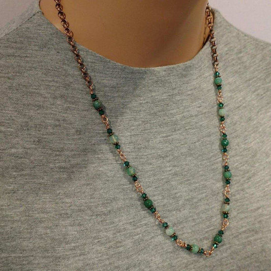 Necklace with green beads and rose gold chain on a mannequin wearing a gray shirt.