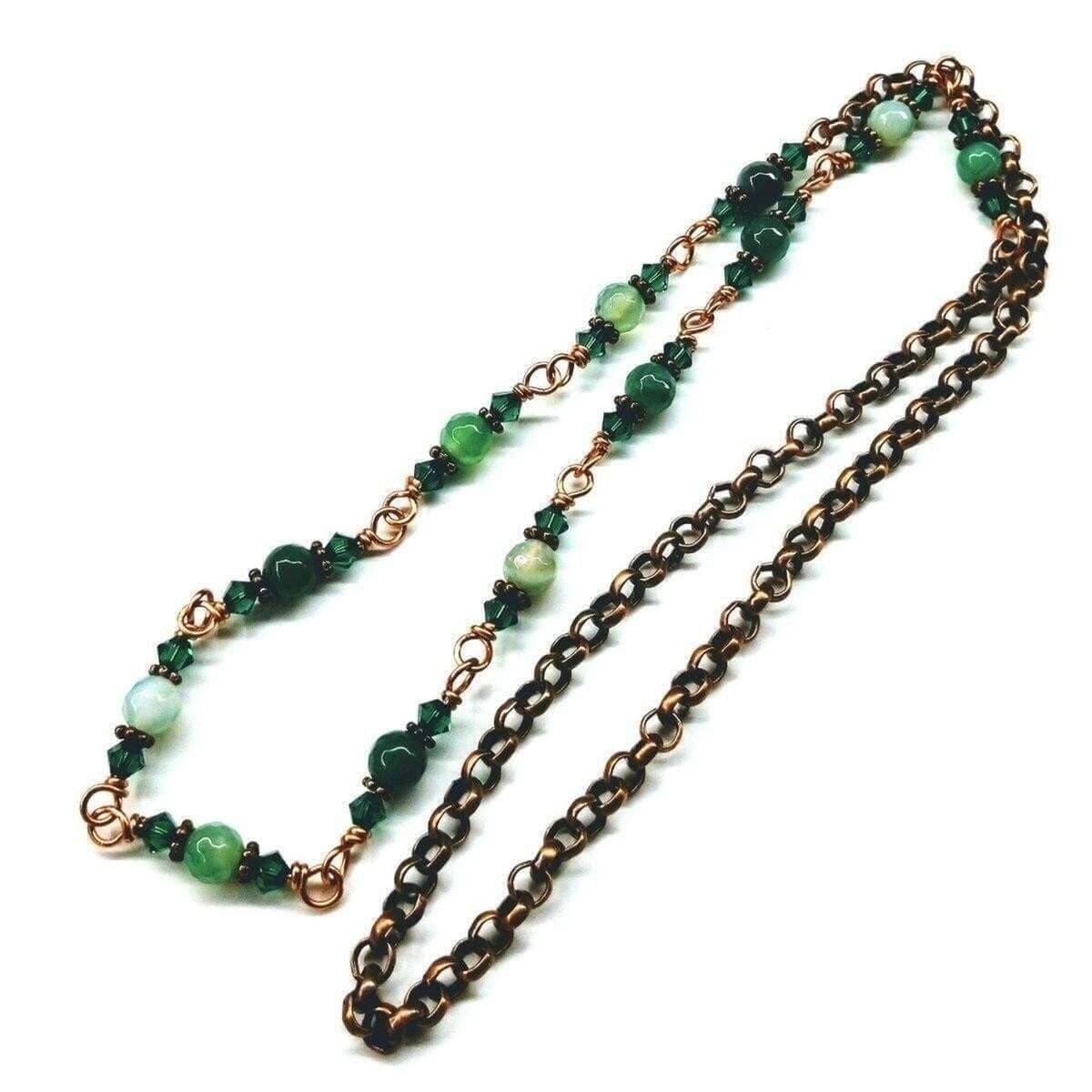 Two necklaces with green beads and bronze chain on a white background
