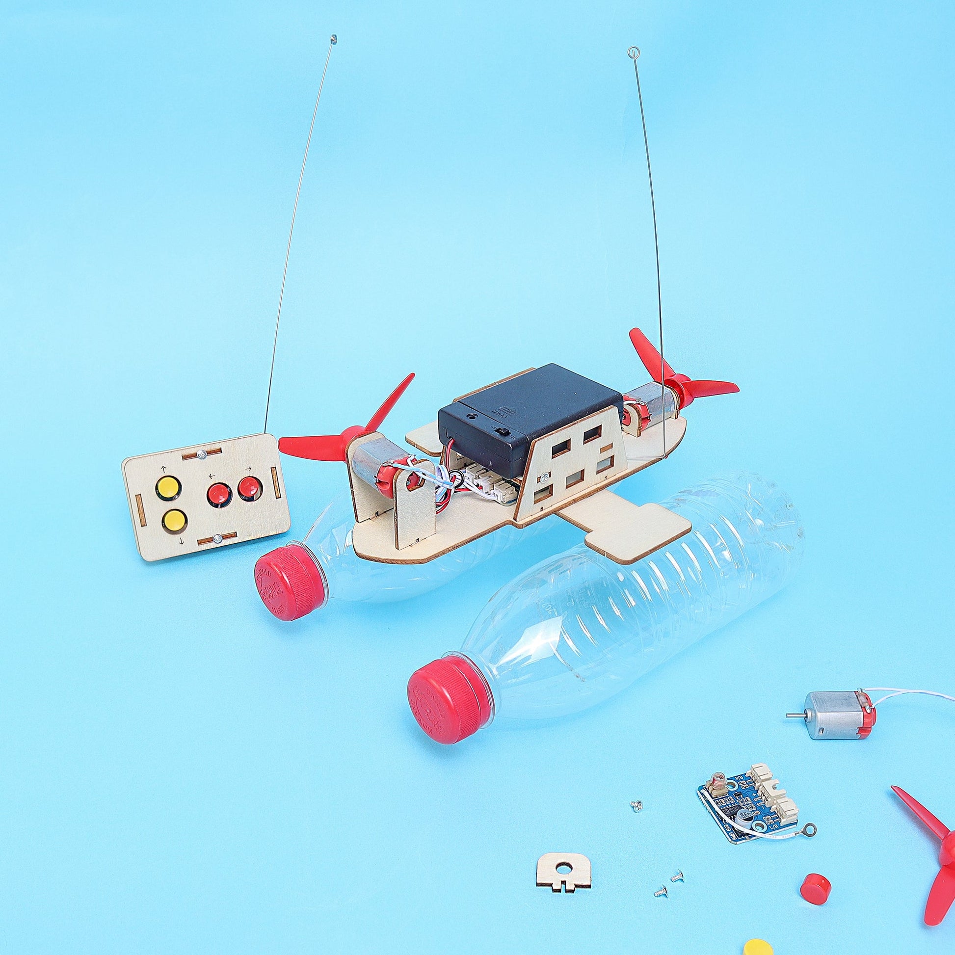 Toy boat with electronic components on a blue background