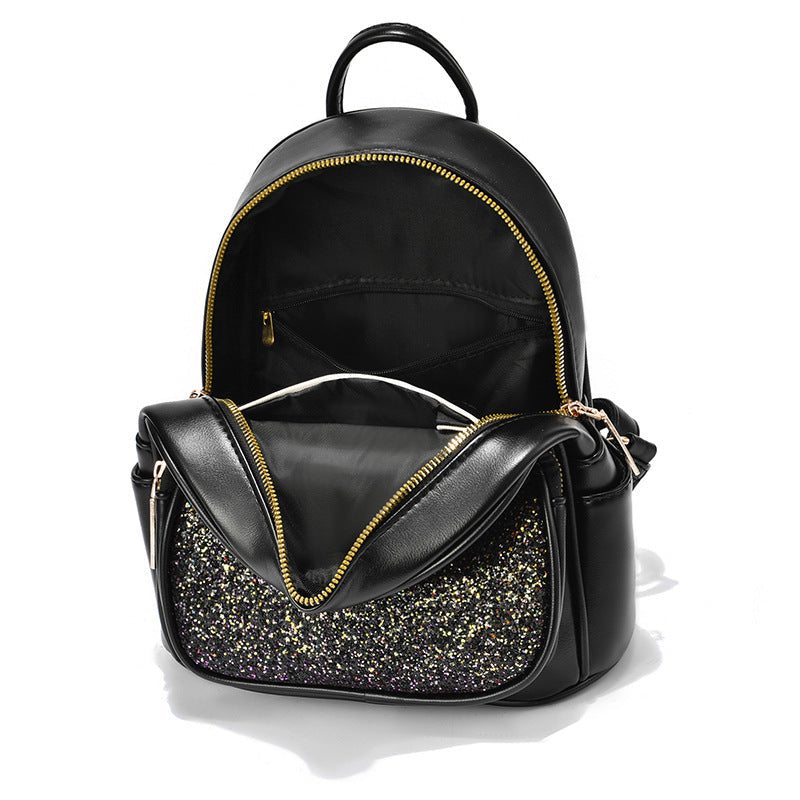 Black backpack with glittery front pocket on a white background