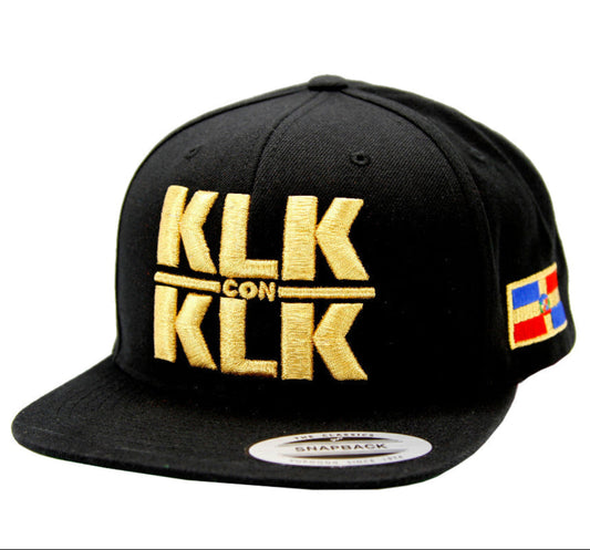 Black cap with gold 'KLK' branding on a white background