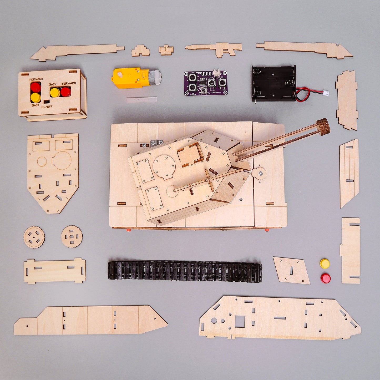 Wooden model kit of a tank with assembled and unassembled parts on a gray background
