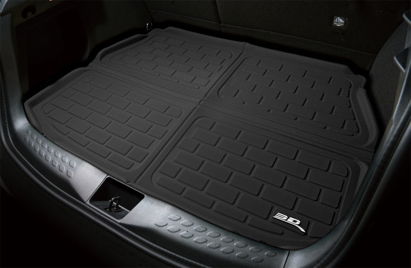 Black car floor mats with a brand logo in a vehicle's cargo area.