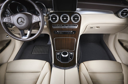 Mercedes-Benz car interior with steering wheel and dashboard.