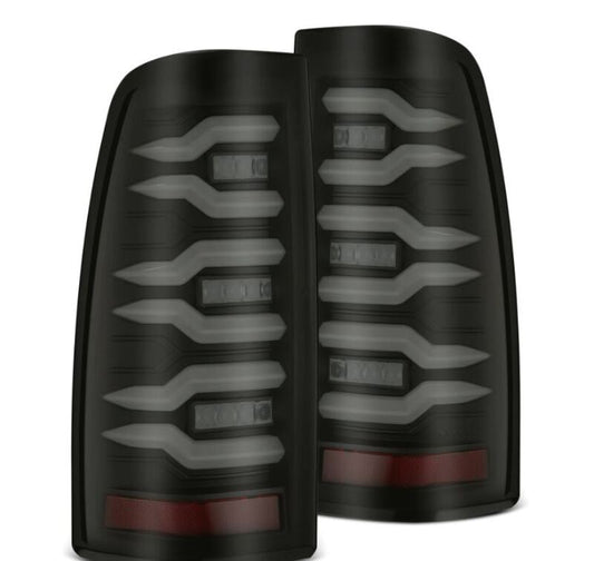 Pair of black car tail lights with red reflectors on a white background
