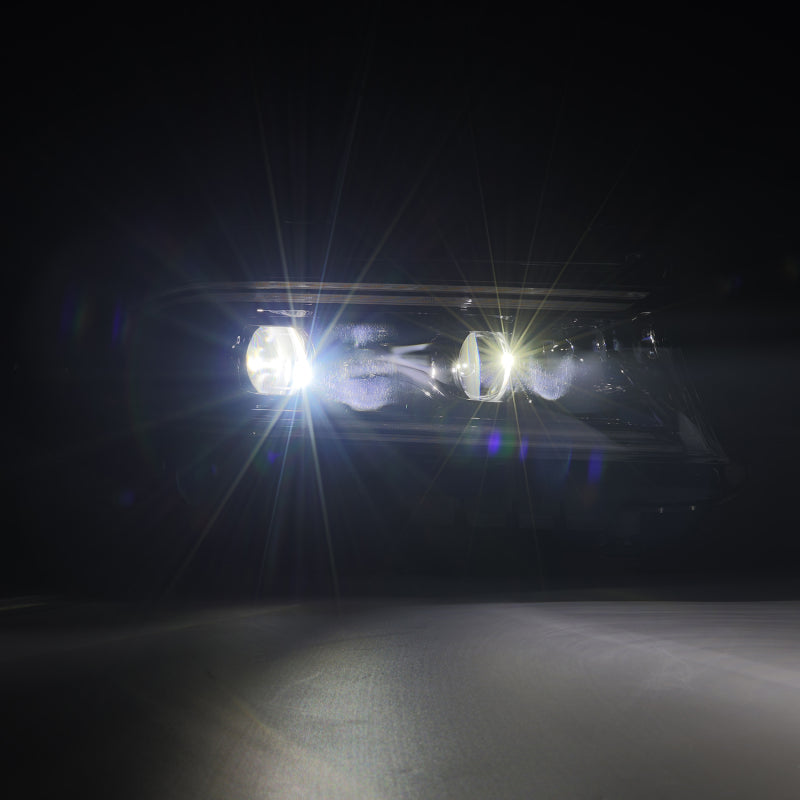Car headlights shining brightly in a dark setting