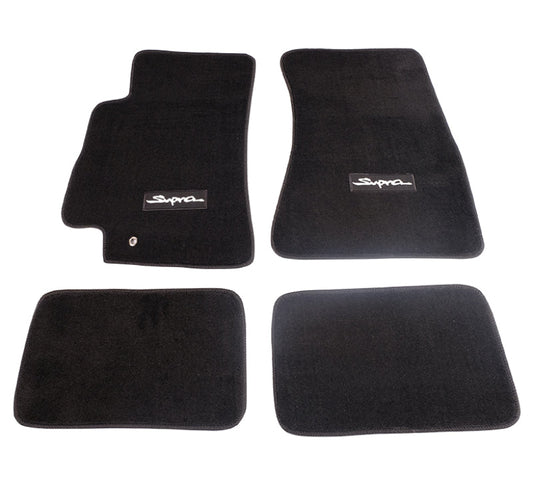 Set of four black car floor mats with 'Supra' logo on a white background