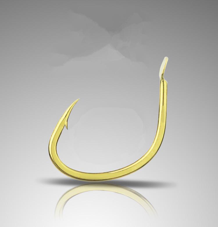 Gold fishing hook on a reflective gray surface