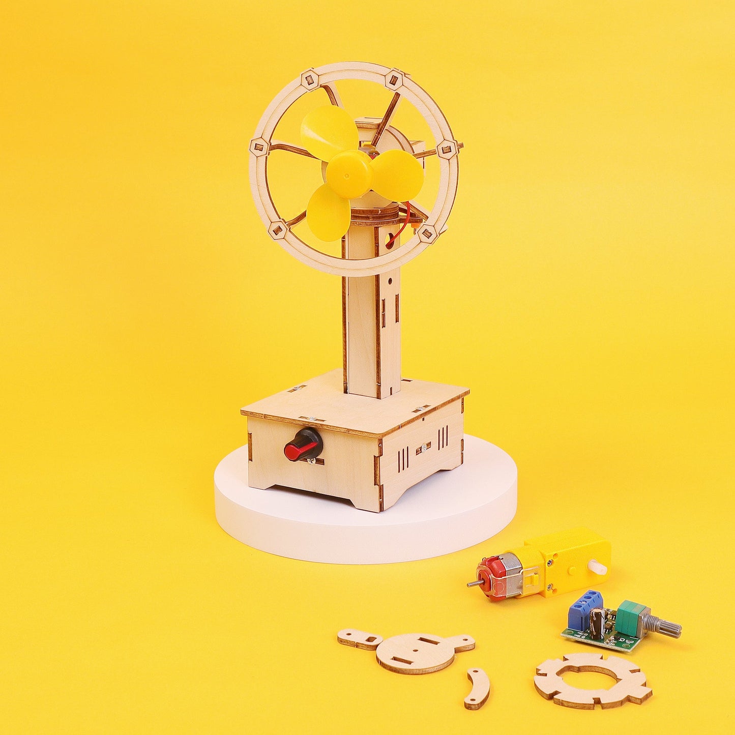 Wooden mechanical model with components on a yellow background