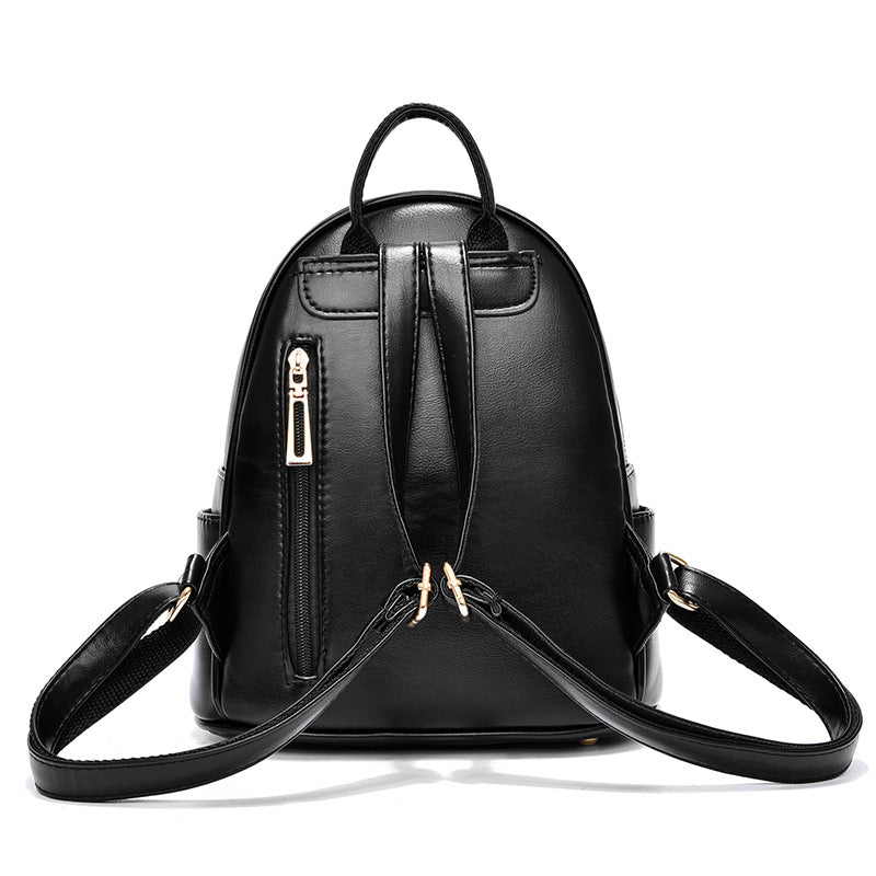 Black backpack with gold zippers on a white background