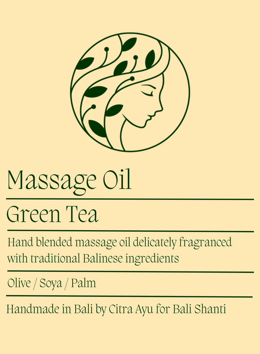 Label for green tea massage oil with a circular design of a woman's face and leaves on a beige background.