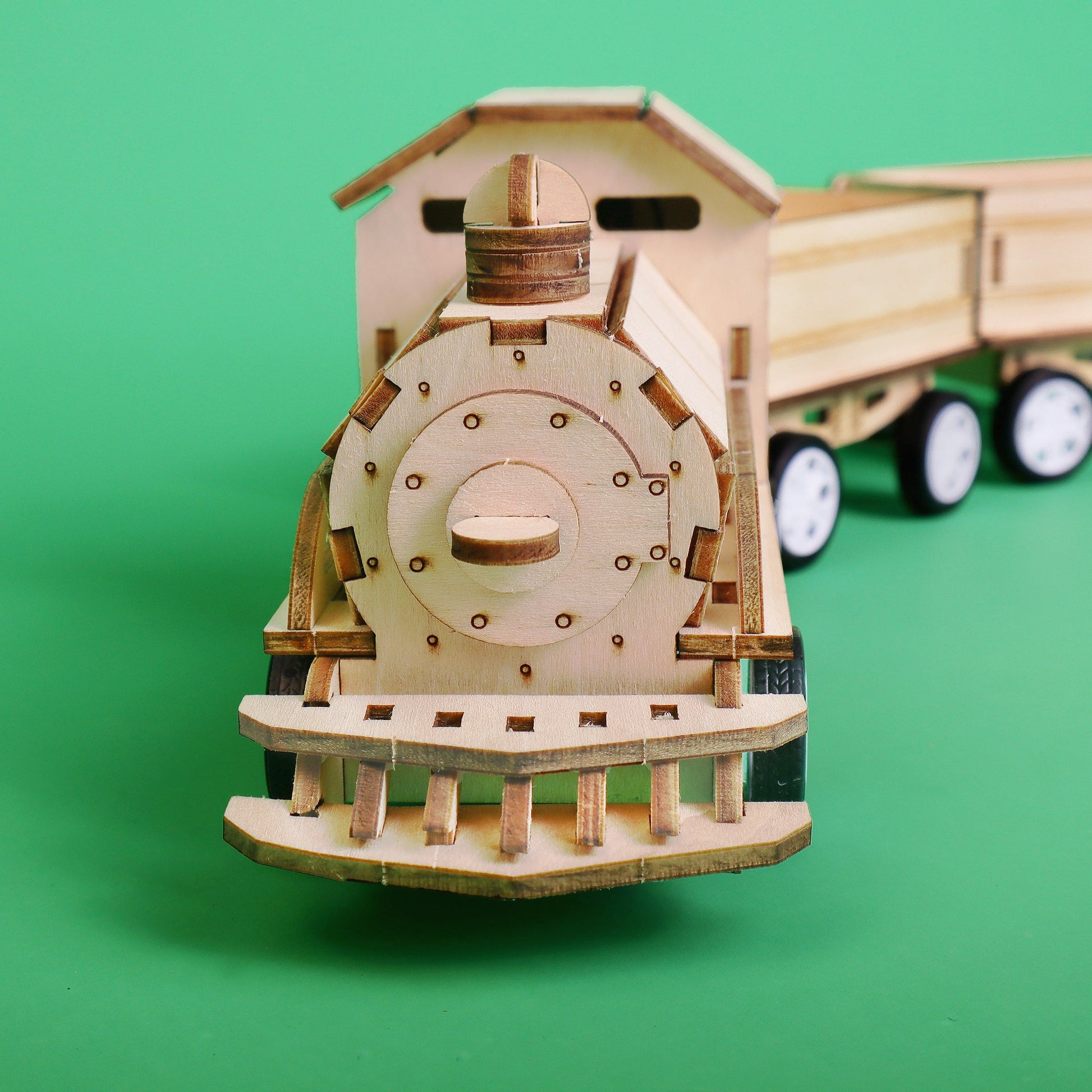 Wooden toy train model on a green background