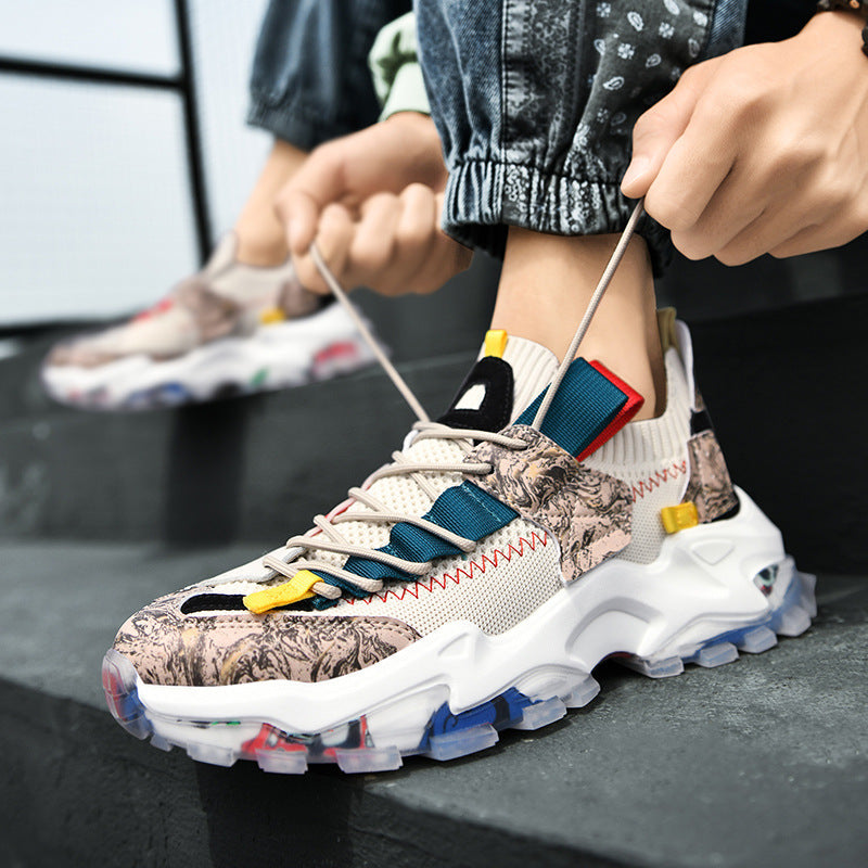 Person wearing a colorful sneaker with a patterned sole, sitting on steps.