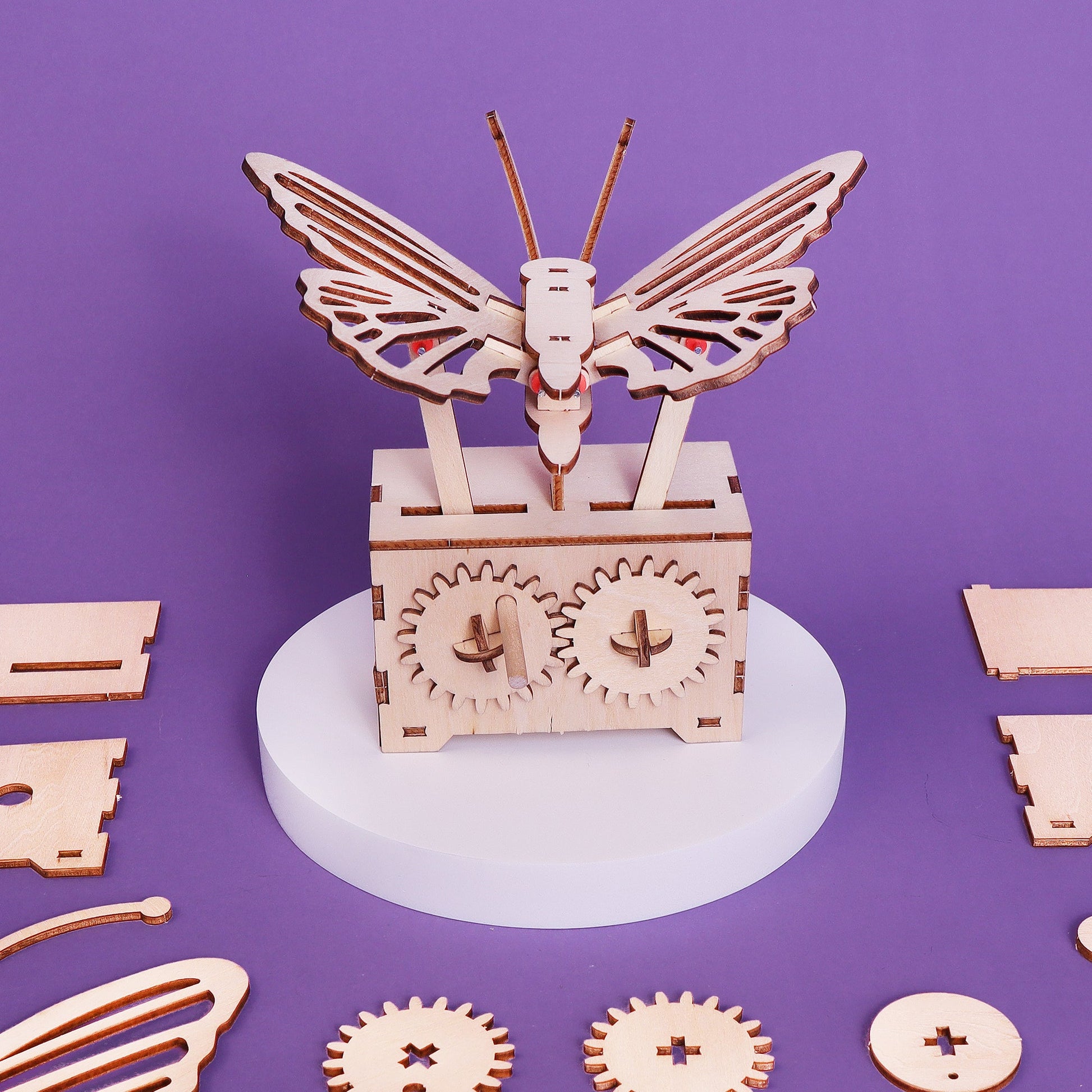 Wooden butterfly mechanism with gears on a purple background