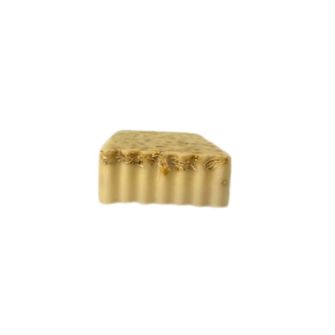 Gold-colored soap bar on a white background