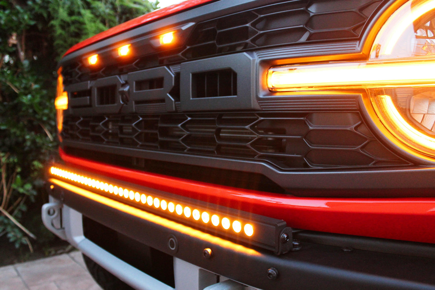 Close-up of a vehicle's front grille with illuminated lights
