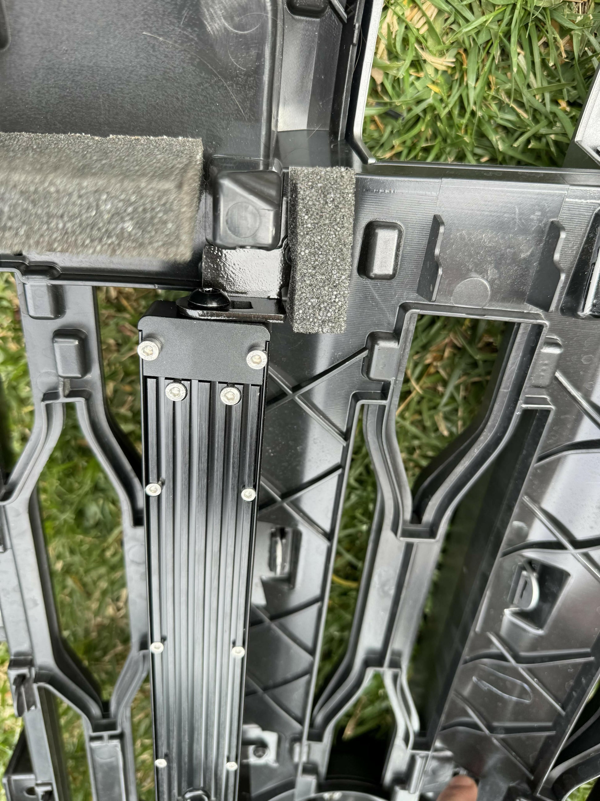 Close-up of a black  LED Light Bars  against a grassy background