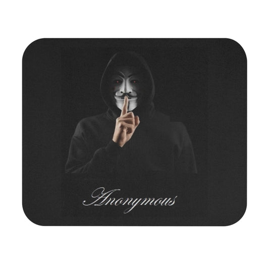 A rectangular mouse pad with rounded corners, featuring a black background with a printed graphic of a person in a black hoodie and Guy Fawkes mask holding up a finger, with the word 'Anonymous' in white script at the bottom.