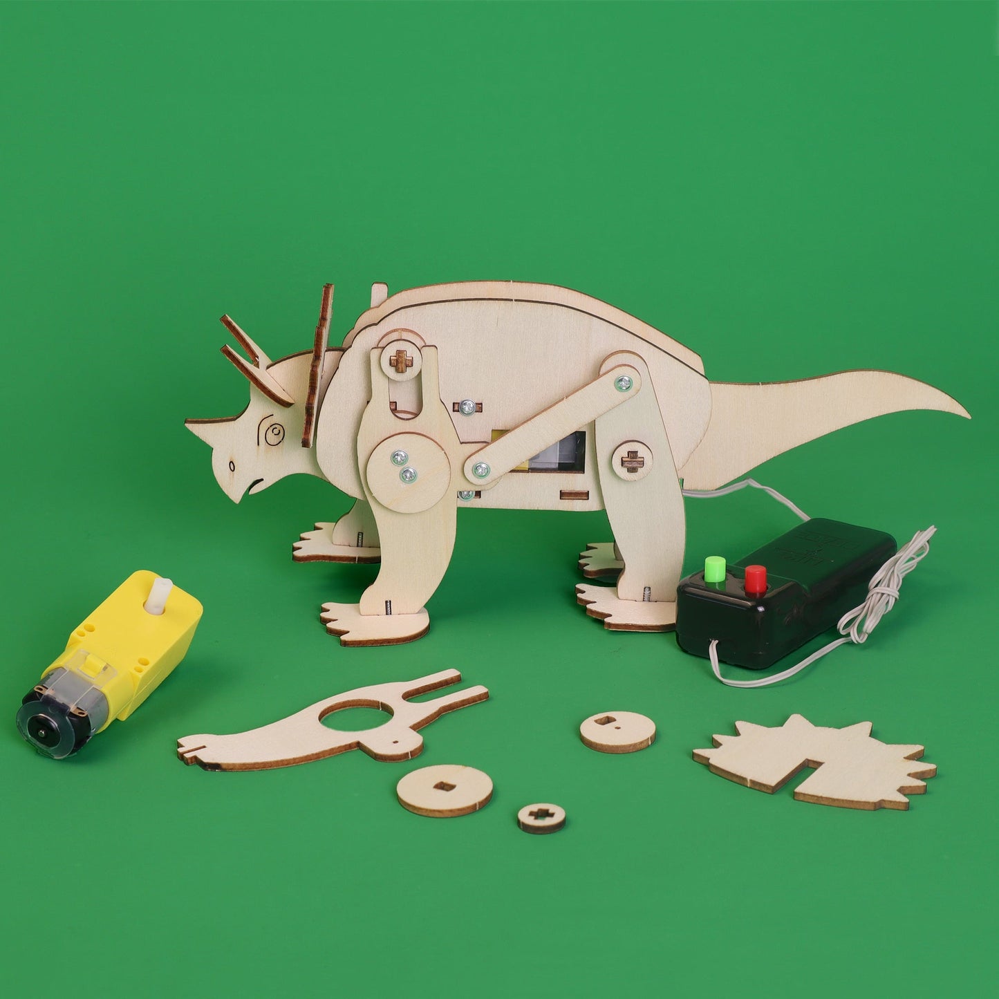 Wooden dinosaur model kit with tools on a green background