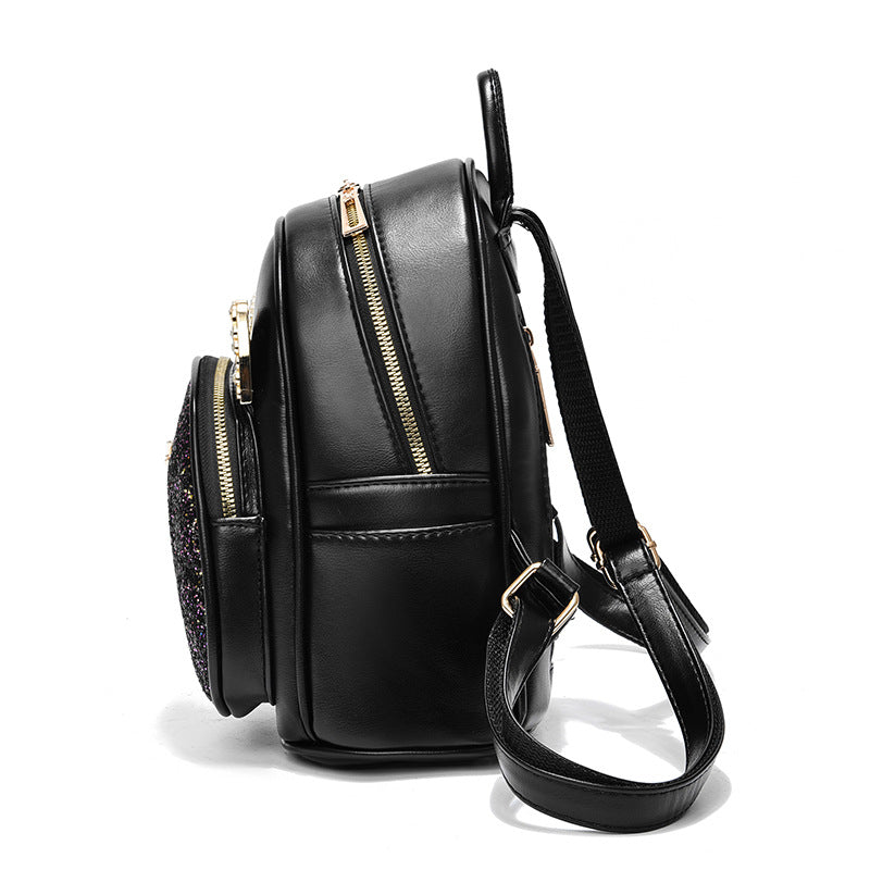 Black backpack with gold zippers on a white background
