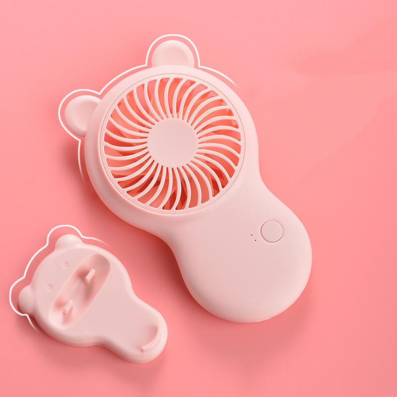 Pink handheld fan with bear design on a pink background