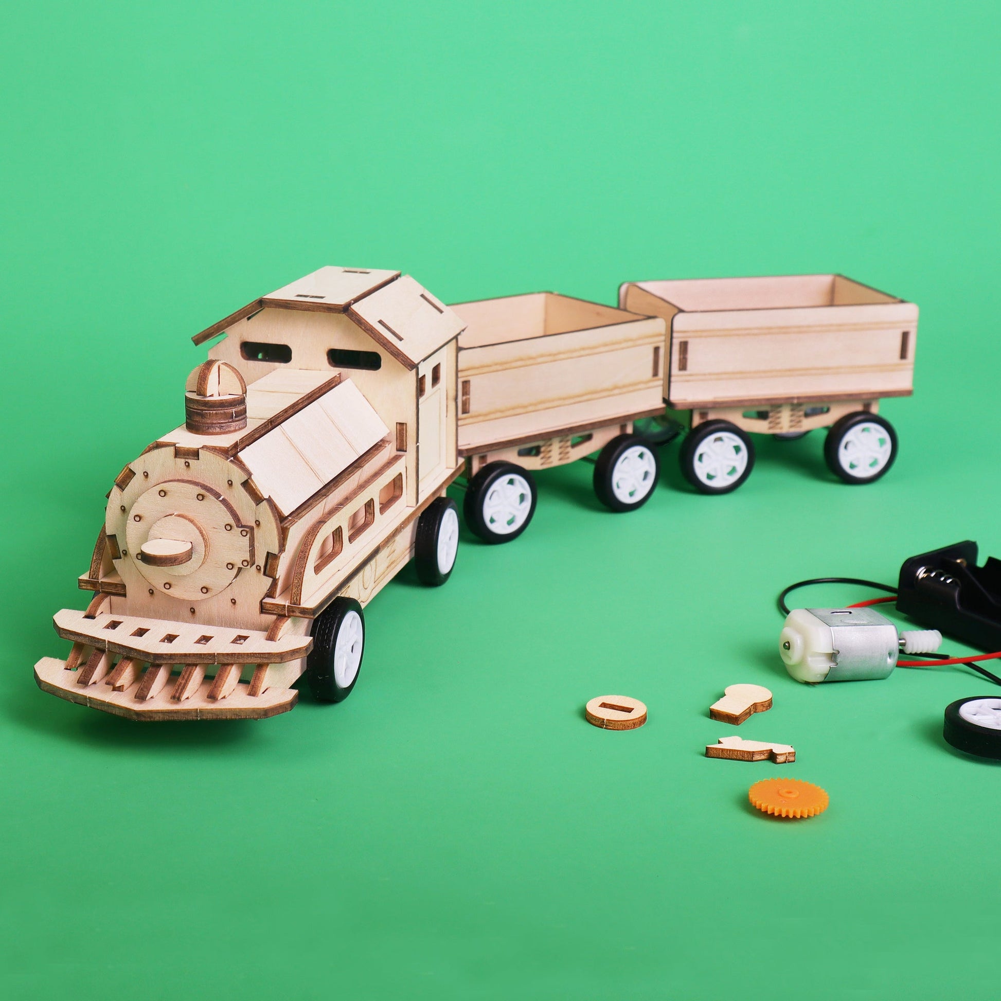 Wooden toy train model with components on a green background