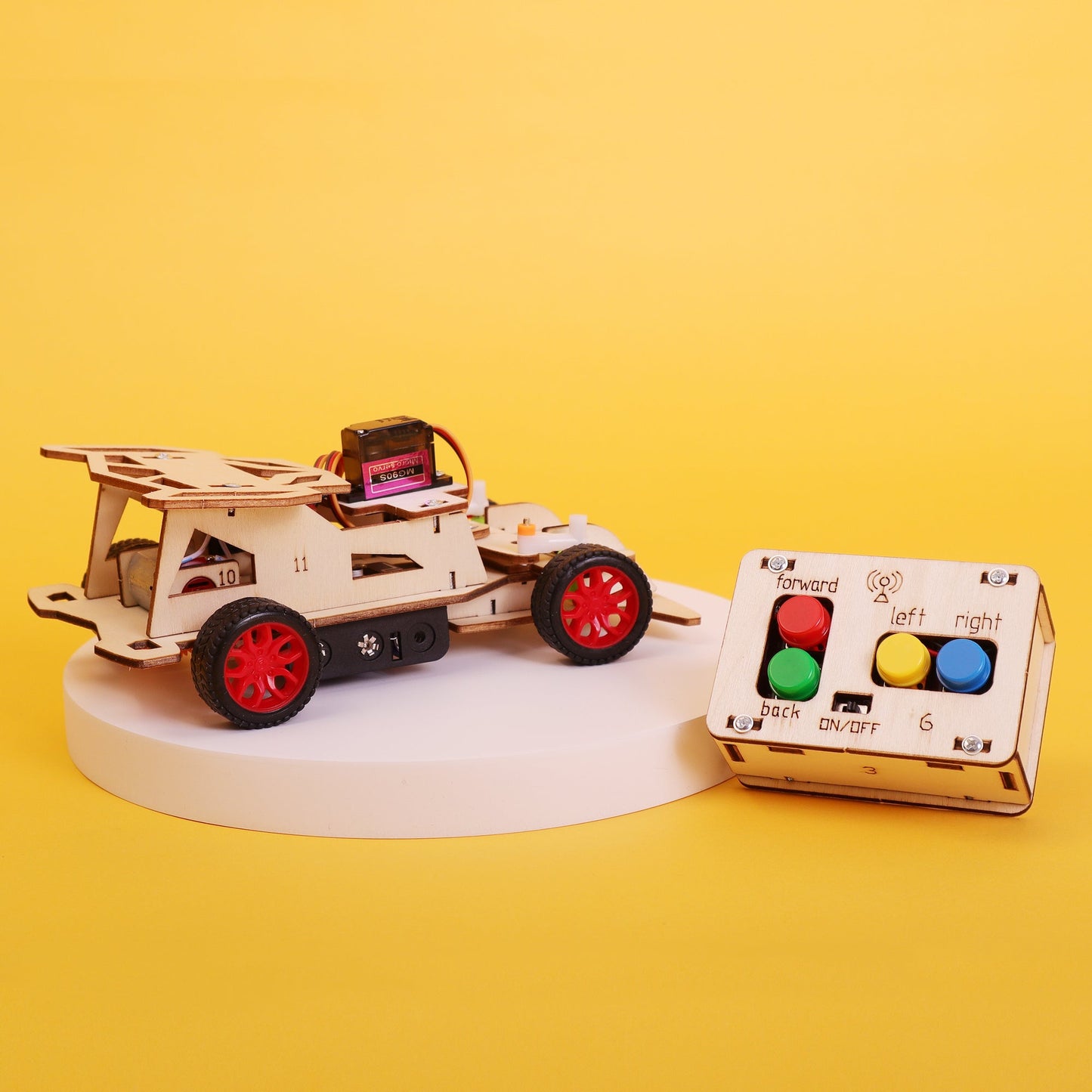 Wooden toy car with remote control on a yellow background