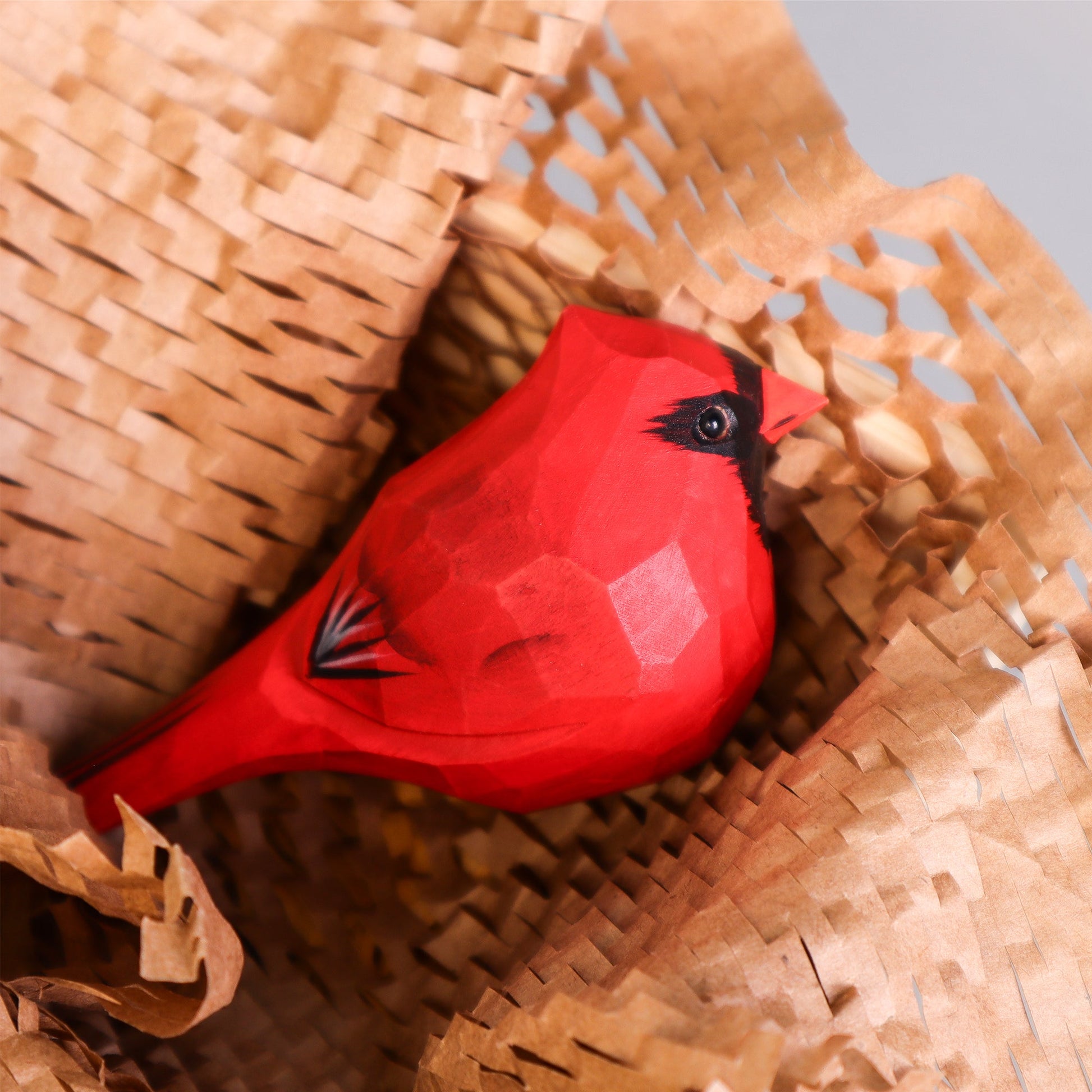 Hand Carved Cardinal Bird on a woven surface