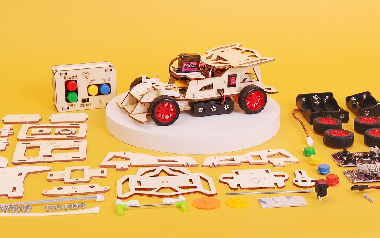 Wooden mechanical model kit with components on a yellow background