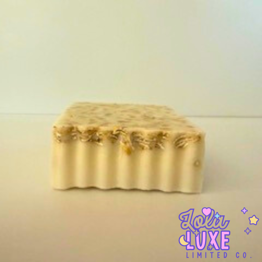 Gold-colored soap bar with 'Loli Luxe Limited Co.' branding on a light background
