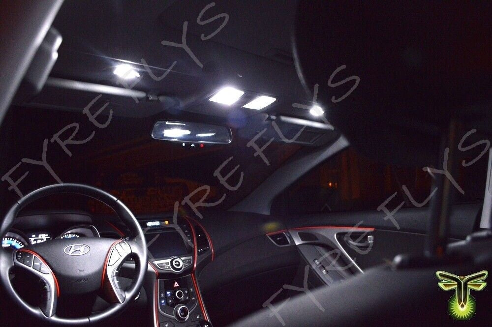Car interior with visible steering wheel and dashboard in a dark setting.