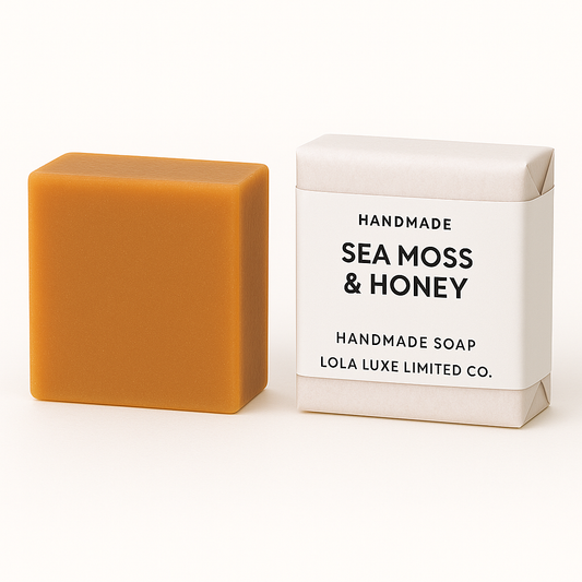 Bar of sea moss and honey soap next to its packaging on a white background