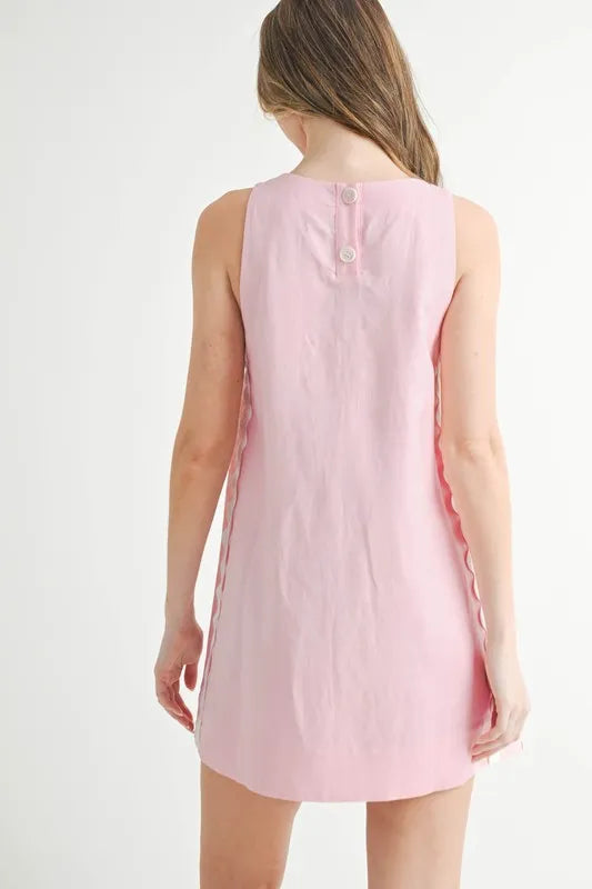Pink sleeveless dress worn by a person on a white background
