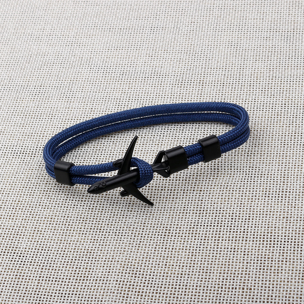Blue bracelet with black clasp on a textured gray background