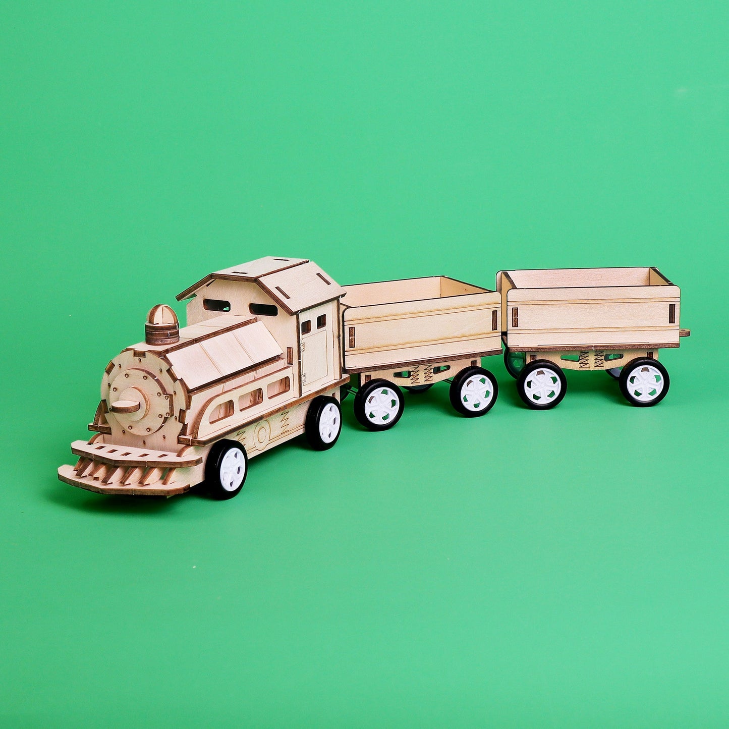 Wooden toy train set on a green background