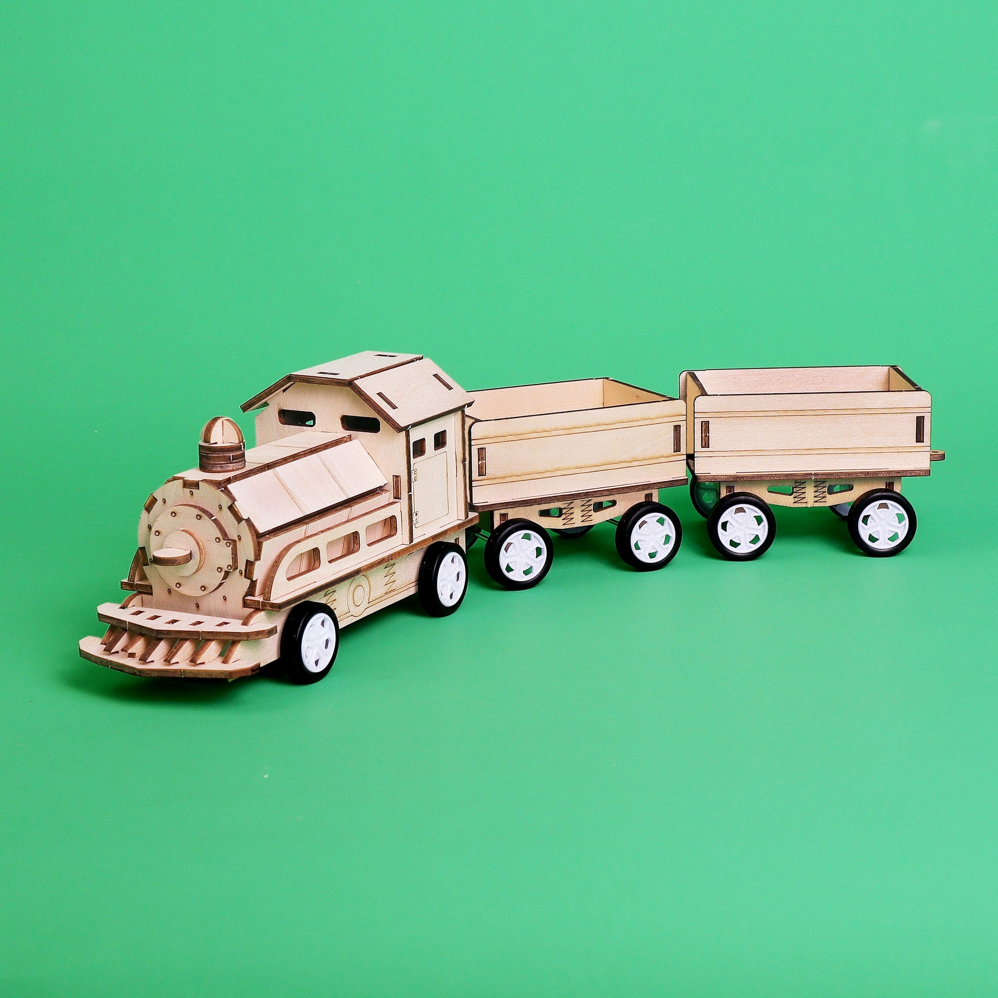 Wooden toy train set on a green background