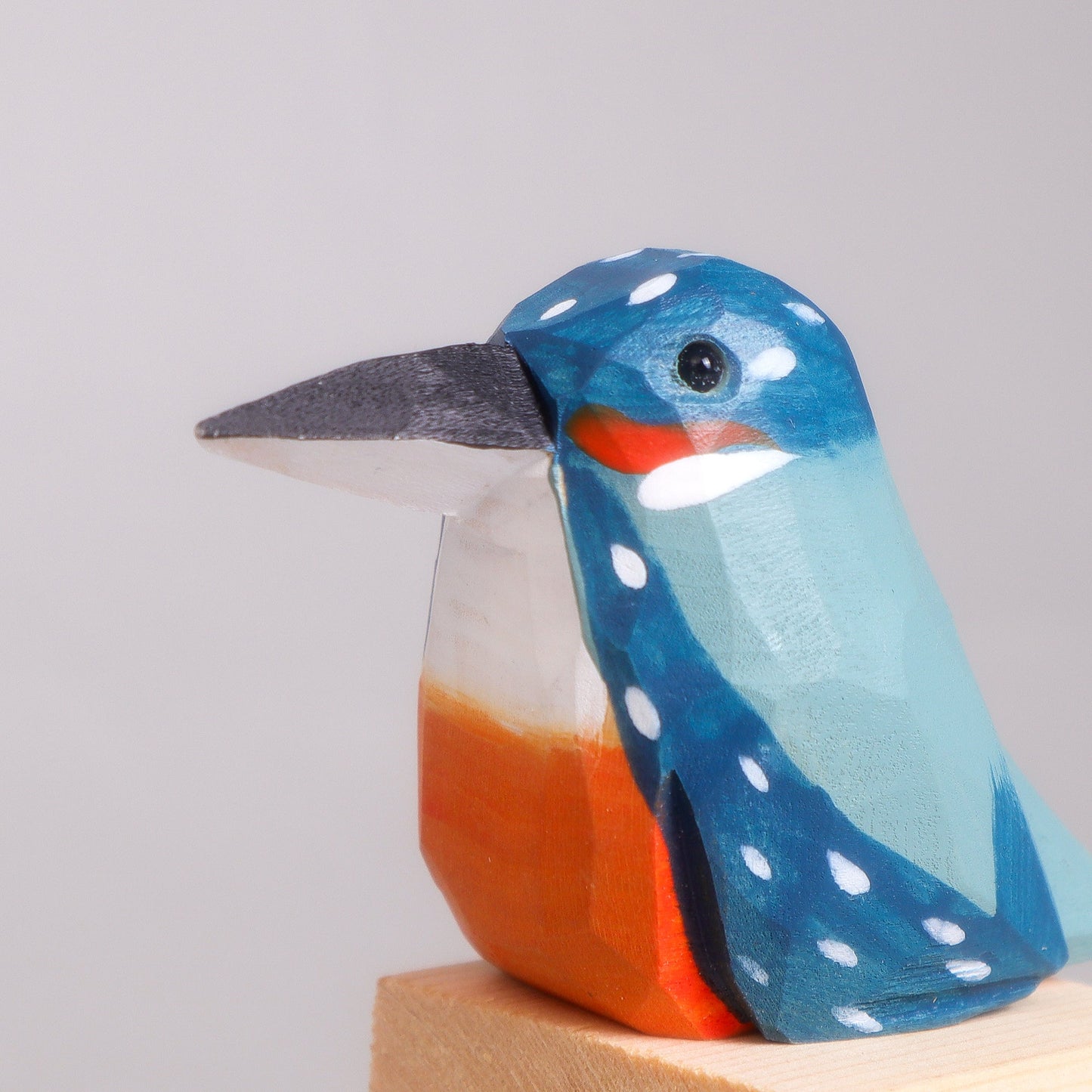 Wooden bird figurine on a white background